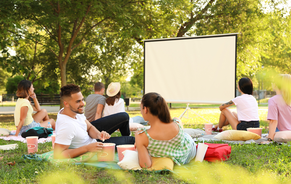 people in front of outdoor movie screen